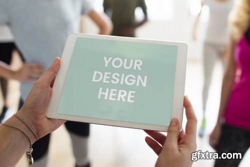 Person holding tablet during yoga class mockup