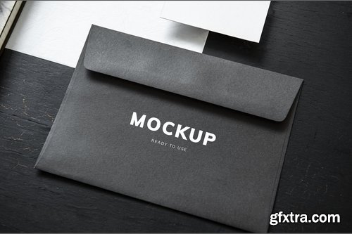 Black envelope mockup on a black table