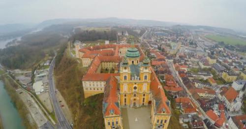 Aerial Shot of Beautiful Melk Abbey in Austria. River Danube. Cold Rainy Weather - KMNJ95P