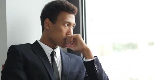 Thinking Pensive Black Businessman in Suit, Looking Through Window - VQSTHNF