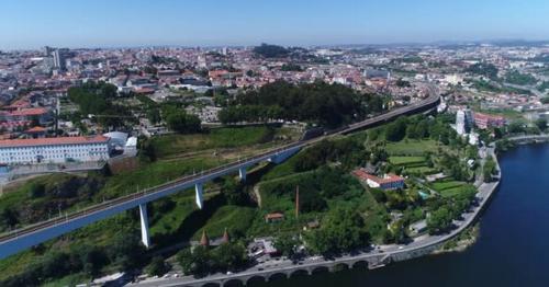 Train Crossing Bridge in Great City - YXFRCV9