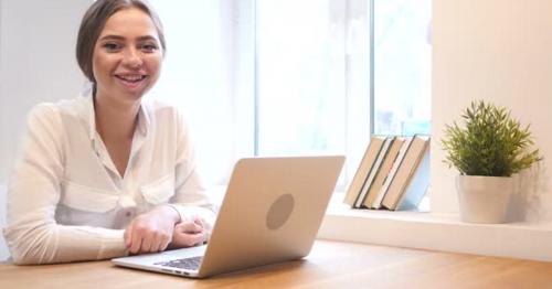 Working Girl in Office Smiling Toward Camera - C5MWDK9