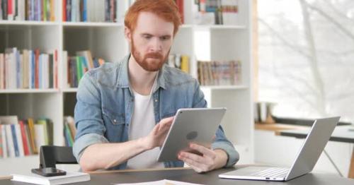 Casual Redhead Man Using Tablet - QMR6LJW