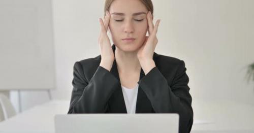 Close Up of Young Businesswoman with Headache Working on Laptop - CY9WR6A