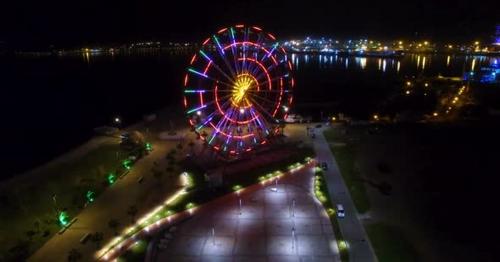 Ferris Wheel Sparking with Lights, Batumi Nightscape Reflecting in Black Sea - HPMZT2N