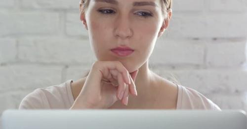 Pensive Woman in Loft Office Busy on Laptop, Thinking - CMXVABT