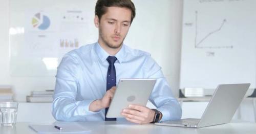 Young Businessman Using Tablet - DLNVRJQ