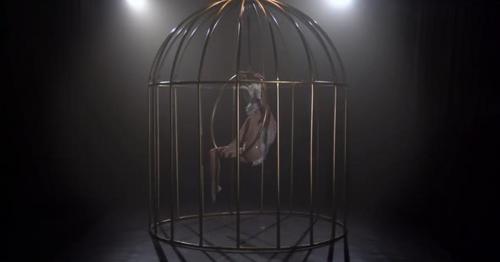 Girl Spinning on a Hoop in a Cage in Dark Studio - N4HJPZE