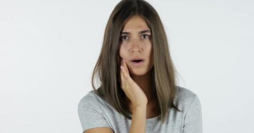 Toothache, Beautiful Girl in Pain, White Background in Studio - KFX2WCR