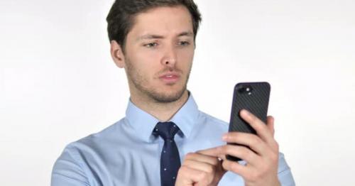 Young Businessman Using Smartphone on White Background - Y4X76SF