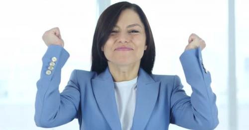 Young Businesswoman Celebrating Success in His Office - 7QGEWYJ