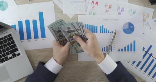 Male Accountant Counting Money and Giving Salary to Office Worker, Business - BE36HTY