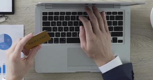 Man Typing Number of Gold Card on Laptop, Online Banking and Payment, Vip Client - U3F8AD7