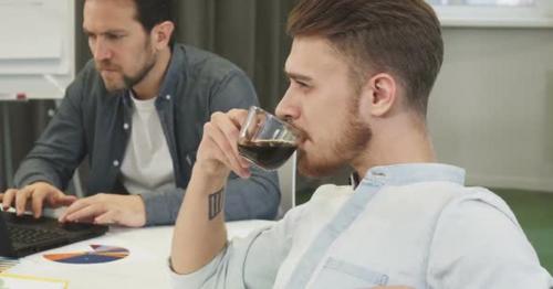 Bearded Handsome Young Businessman Drinking Coffee Thinking Looking Away - G48VKFN