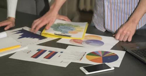 Cropped Close Up of a Table at the Corporate Office Full of Business Diagrams - 2HKZLQY