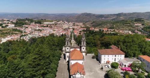 Flying Over Old Monastery with City in the Background - WZNYKLA