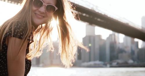 Happy Girl in Sunglasses with Amazing Golden Hair Blowing in the Wind Smiling at Camera at Brooklyn - MJTKDCU