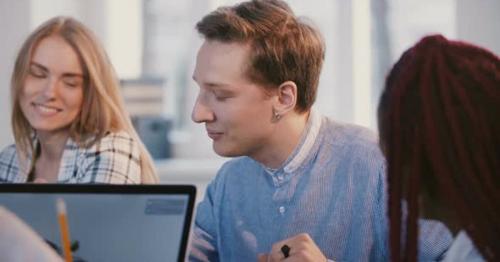 Medium Shot Portrait of Young Happy Successful Male Caucasian Office Worker Talking Behind Office - VTW7GZP