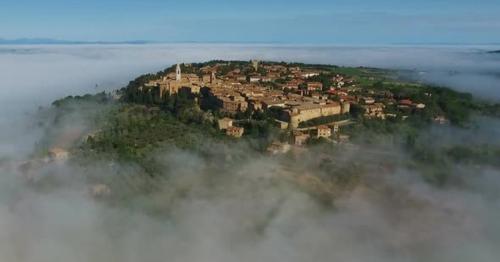 Old Italian City on Top of Hill in Fog Tuscany - C6ZPBVE