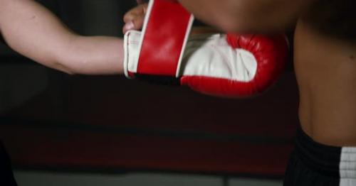 Coach Helps Women Boxer To Put On Gloves 17b - A5HLT7C