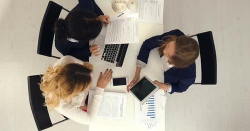 Three Business Women Working Together with Documets and Tablet Computer in the Office - LKUPVJE