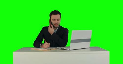 Young Business Man Speaking on the Phone in Office. on a Green Screen - YGNML8W