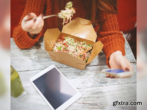 Woman Using Smartphone and Tablet While Eating Takeout Mockup 220158404
