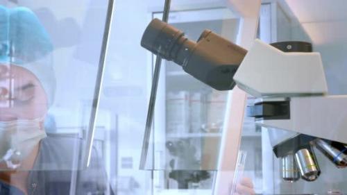 Videohive - Female Scientist Looking Microscope Eyepiece. Portrait of Woman Scientist Looking Through Microscope