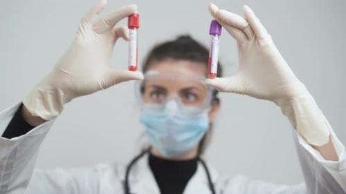 Videohive - Doctor Comparing Blood Samples From Corona Positive Patients at Laboratory