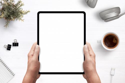 Tablet In Man Hands Mockup Above Work Desk With Separated Layers For Creating A Scene Premium PSD