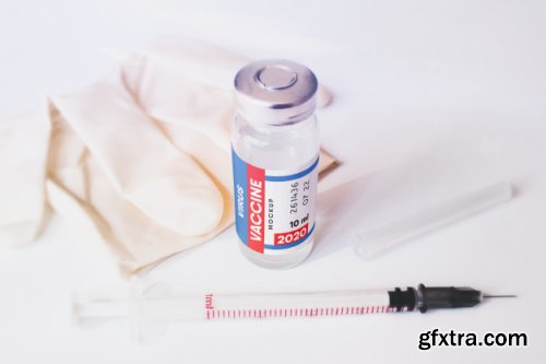 Vaccine bottle with syringe and medical gloves scene mockup