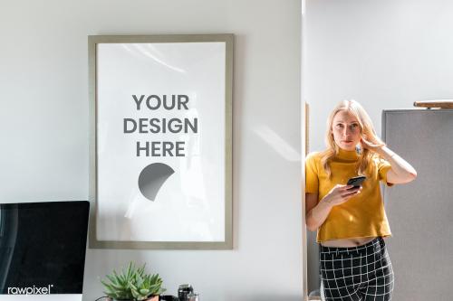 Woman standing by a picture frame mockup - 2203480