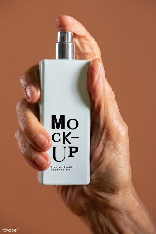 Hand holding a white refillable spray bottle mockup - 2210590