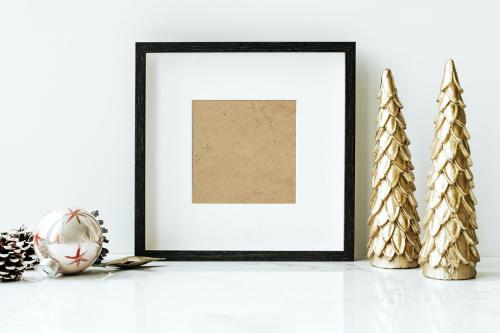 Picture frame on a table with golden Christmas tree - 1231308