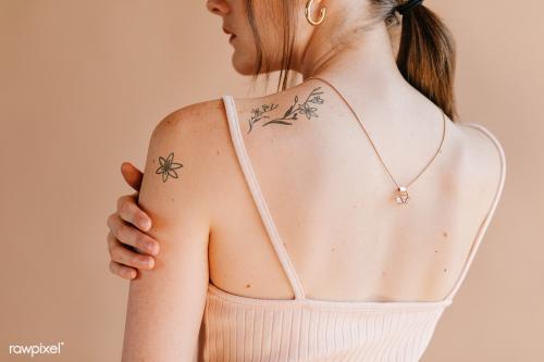 Woman with floral tattoos on her shoulder - 1235368