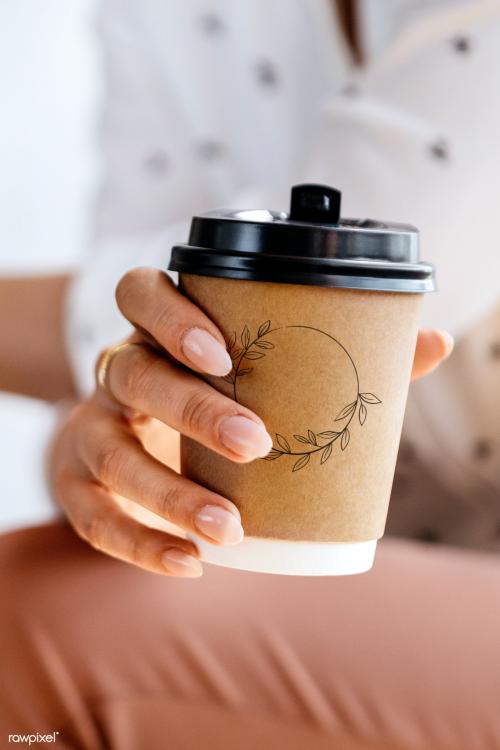 Woman holding a coffee cup mockup - 2030441