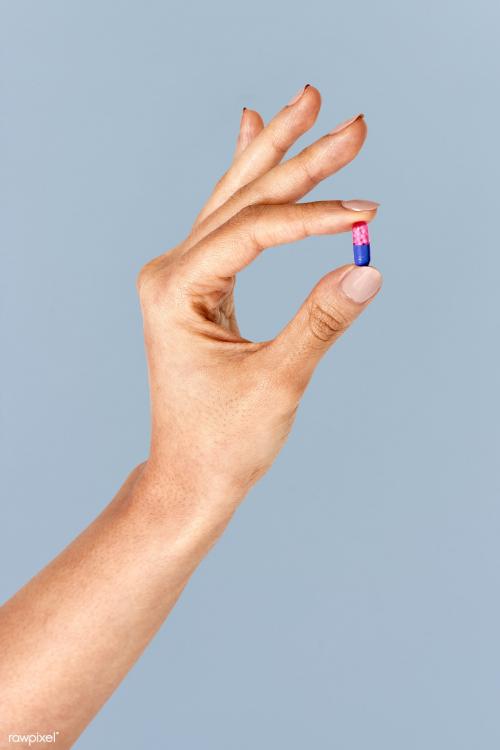 Hand holding a pink and blue pill mockup - 2052992