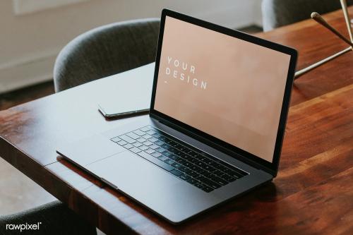 Laptop mockup on a wooden table in a meeting room - 1216558