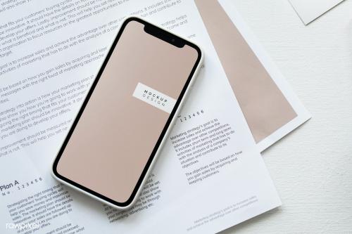 Mobile phone mockup on a paper - 1220985