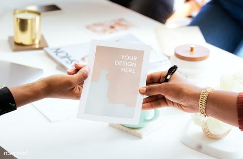 Woman handing a paper mockup in the meeting room - 1221002