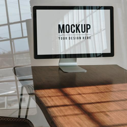 Computer screen mockup on a wooden table - 1221550