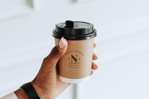 Hand holding a coffee cup mockup - 1224223