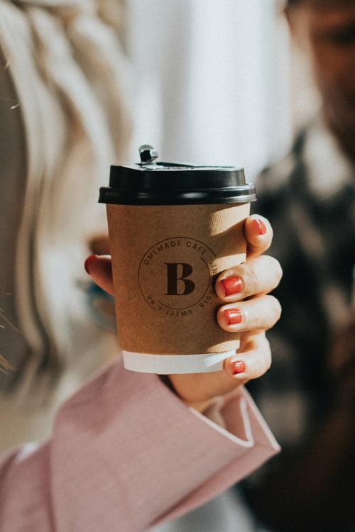 Female hand holding a coffee cup mockup - 1224313