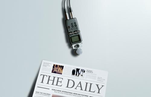 Portable sound recorder and a newspaper on a table - 1225622