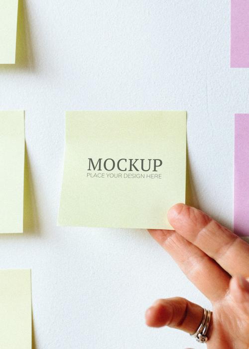 Woman holding a yellow sticky note mockup - 1226457