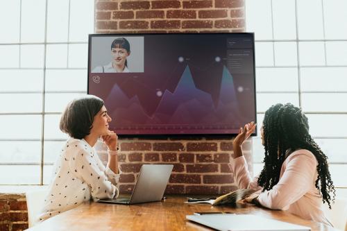 Diverse colleagues having a conference with a tv screen mockup - 1226475
