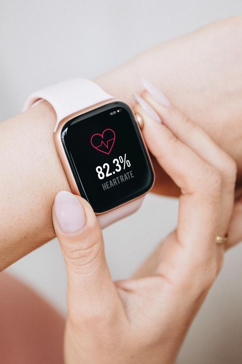 Woman wearing a smartwatch mockup to check her heart rate - 1226575