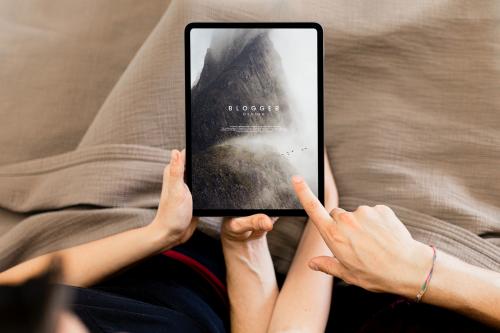 Couple using a tablet screen mockup together in bed - 1226999