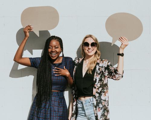 Cheerful women showing blank speech bubbles - 1208348