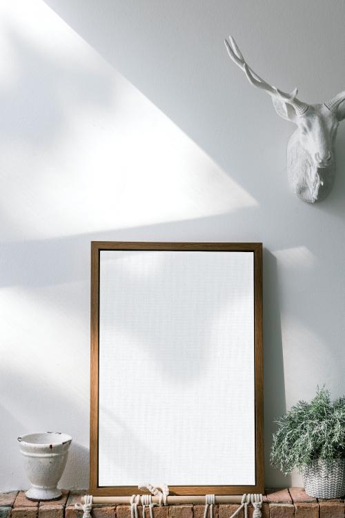 Wooden frame mockup against a white wall - 1210108